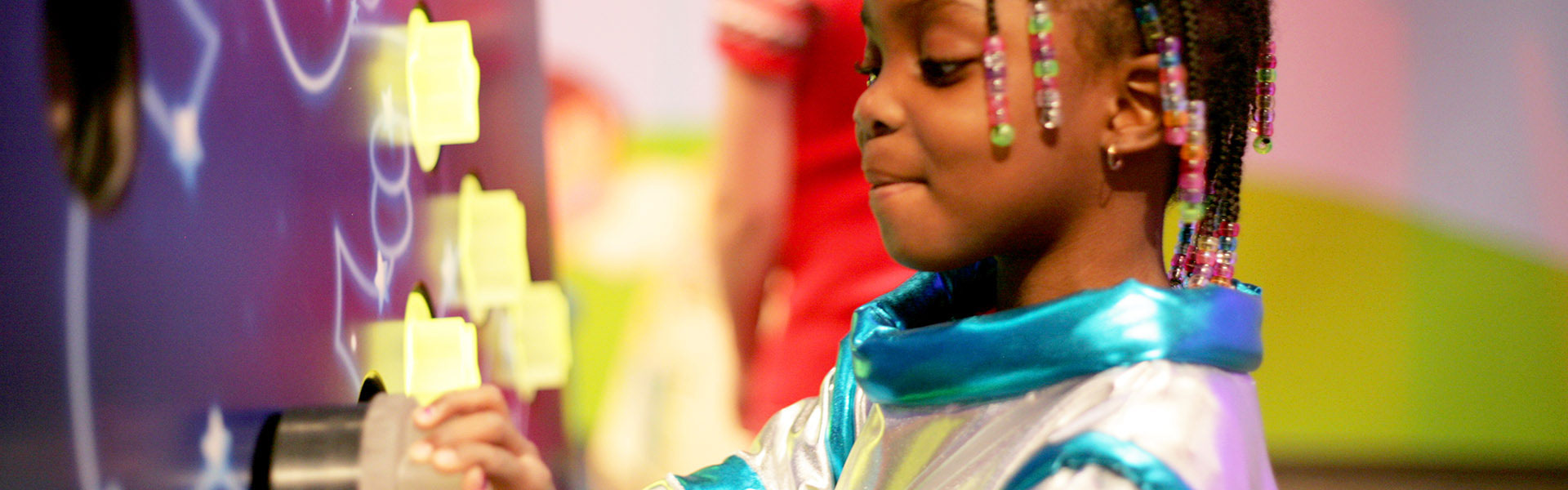 Young girl playing at a museum exhibit